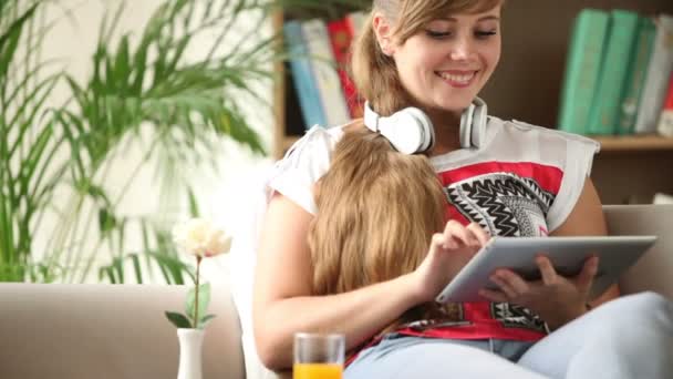 Girl in headset relaxing on sofa — Stock Video