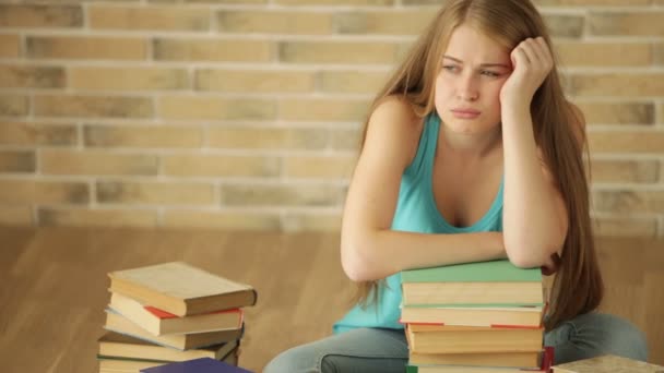 Chica estudiante cansado con pila de libros — Vídeo de stock