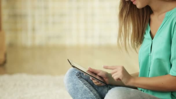 Meisje, zittend op de vloer met behulp van de touchpad — Stockvideo