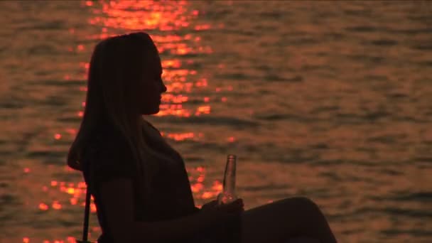 The girl drinking and  sitting on a armchair — Stock Video