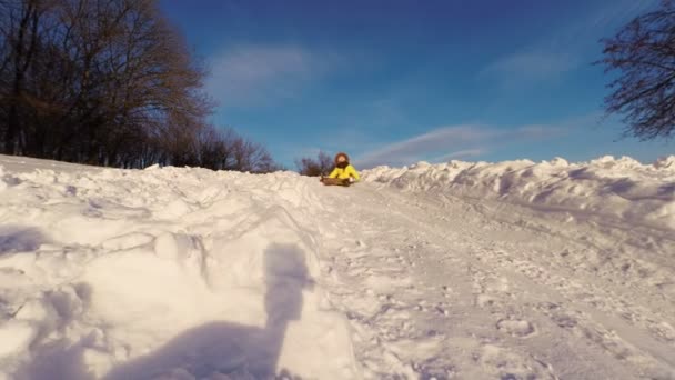 雪の丘の下の乗車の子供 — ストック動画