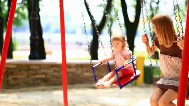 The child and his mother  on a swing — Stock Video