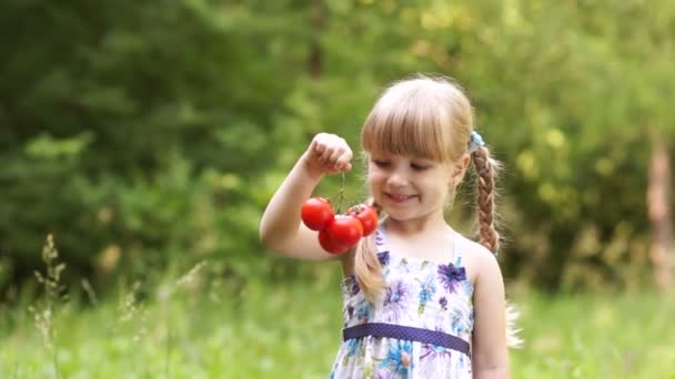 Kind houden een tomaten. — Stockvideo