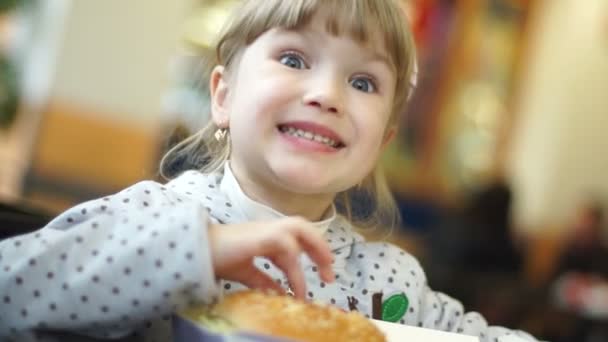 Girl eating big burger. — Stock Video