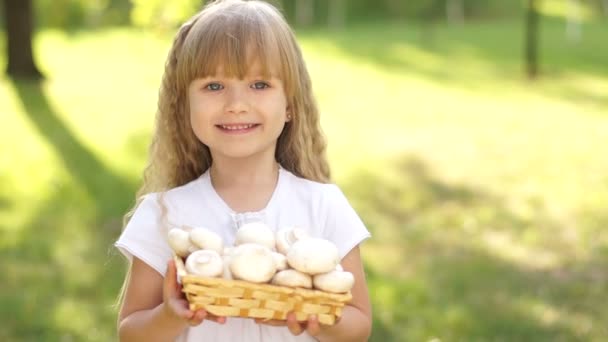 Little girl with a basket of mushrooms. — Stock Video