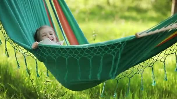 Little girl lying in a hammock — Stock Video