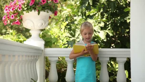 Criança feliz lendo um livro — Vídeo de Stock