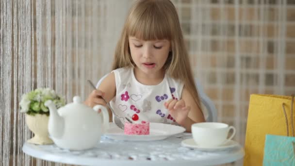 Girl sitting at cafe eating cake — Stock Video