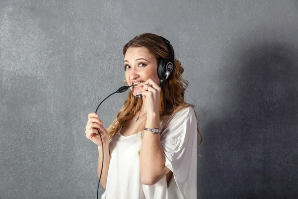 Woman in call center with phone headset — Stock Photo, Image