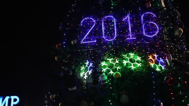 Lit 2016 sign on illuminated Christmas tree — Stock Video