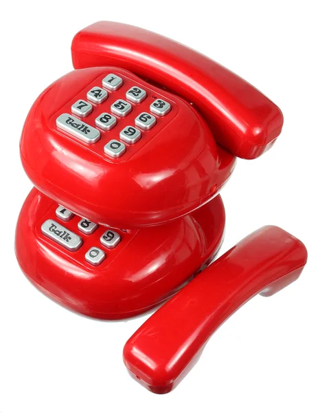 Телефоны с красными игрушками — стоковое фото