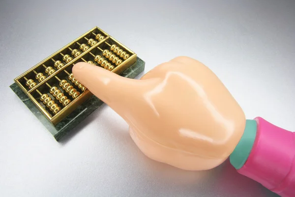 Plastic Hand with Miniature Abacus — Stock Photo, Image