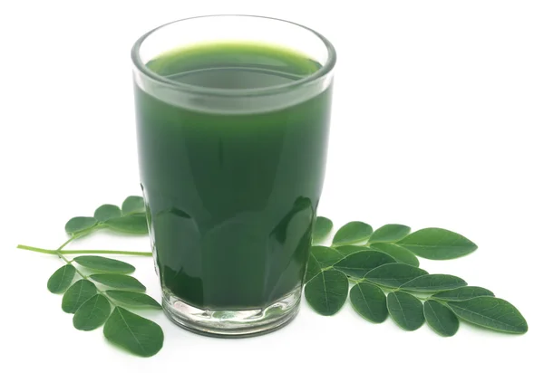 Moringa leaves with extract in a glass — Stock Photo, Image
