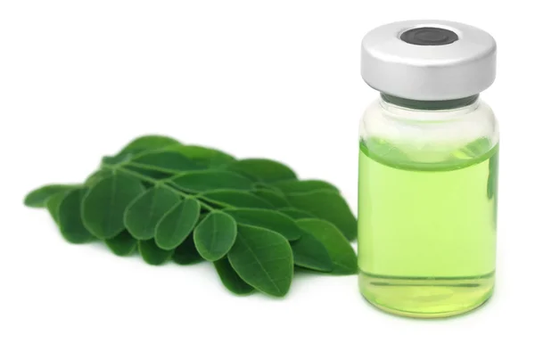 Moringa leaves with extract in a vial — Stockfoto