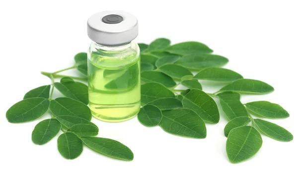 Moringa leaves with extract in a vial — Stockfoto