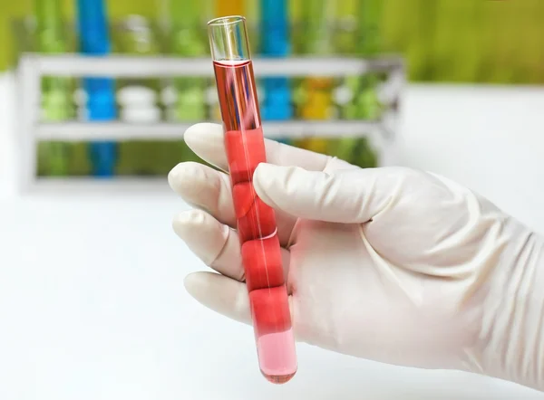 Hand holding a test tube — Stock Photo, Image