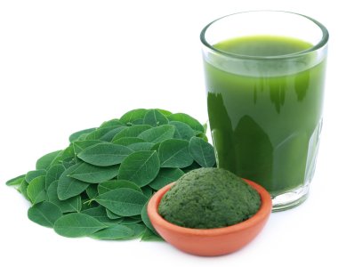 Edible moringa leaves with extract and ground paste clipart