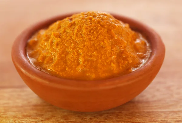 Raw turmeric paste in a bowl — Stock Photo, Image