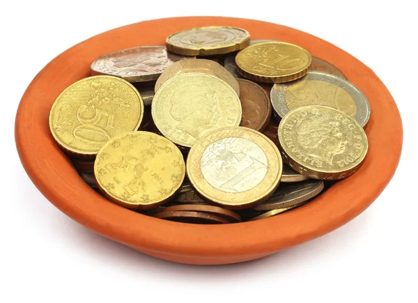 Coins in a bowl over white background — Stock Photo, Image