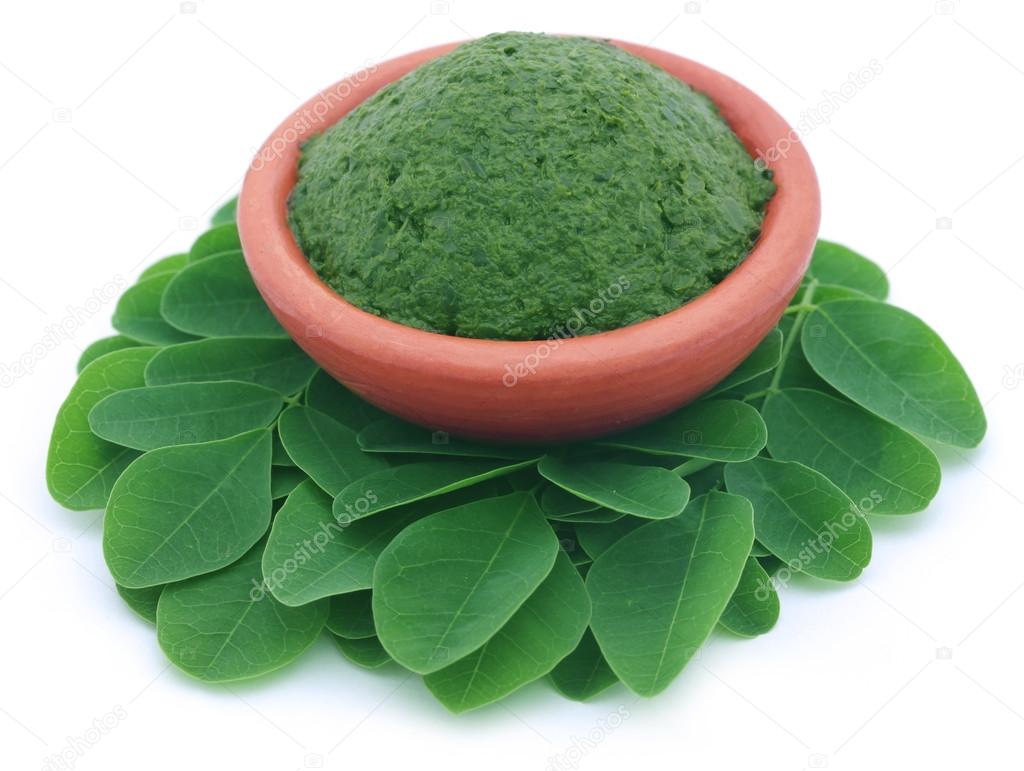 Edible moringa leaves with mashed ones in a pottery