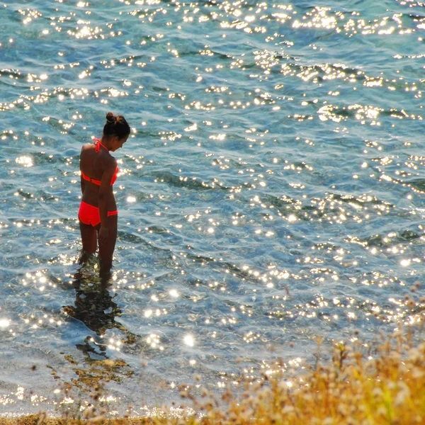 Girl in sunny sea water — Stock Photo, Image