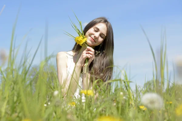 Vrouw met paardebloemen — Stockfoto