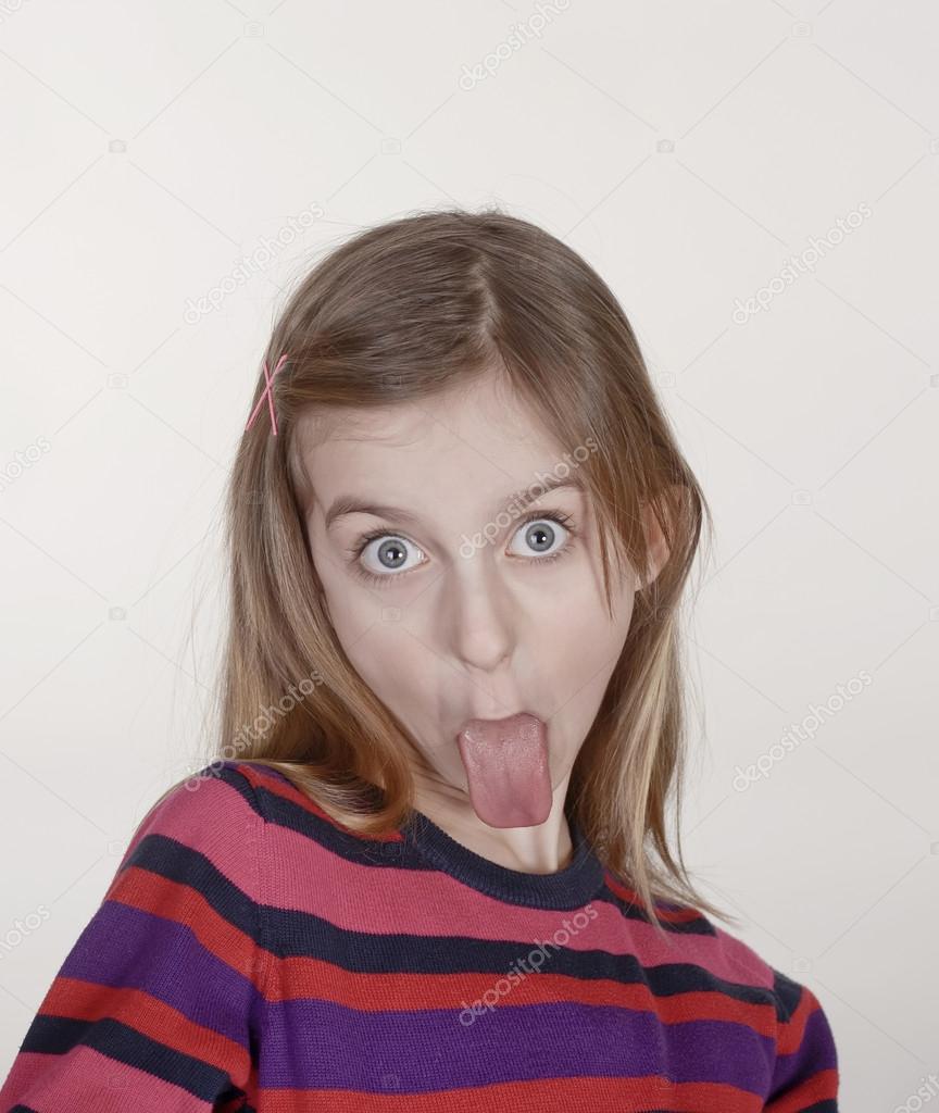 Girl puts out her tongue Stock Photo by ©luna123 99364222