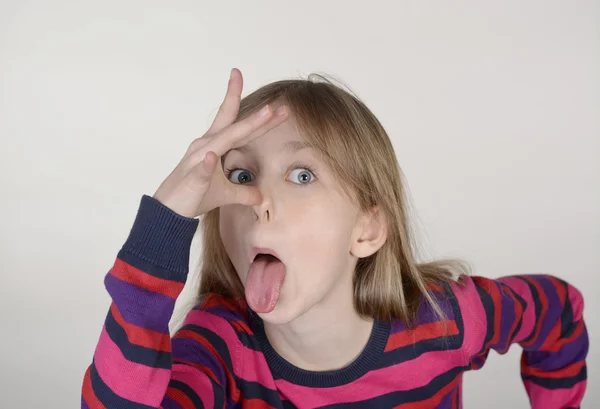 Girl puts out her tongue — Stock Photo, Image