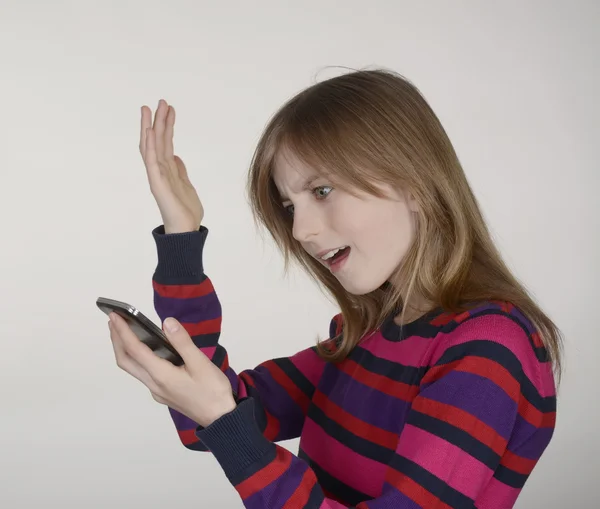 Irritated girl with smartphone — Stock Photo, Image