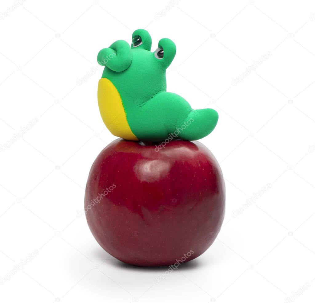Plasticine worm on the apple isolated on the white background
