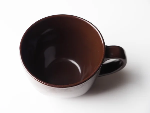 Braune Tasse auf hellem Hintergrund — Stockfoto