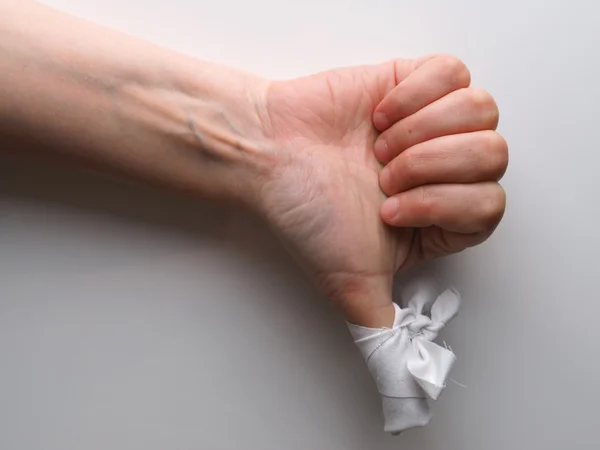 Bandaged finger on a gray background — Stock Photo, Image
