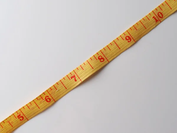 Measuring tape on a gray background — Stock Photo, Image