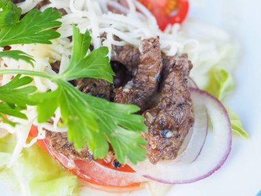 Mavi ahşap arka planda et salatası