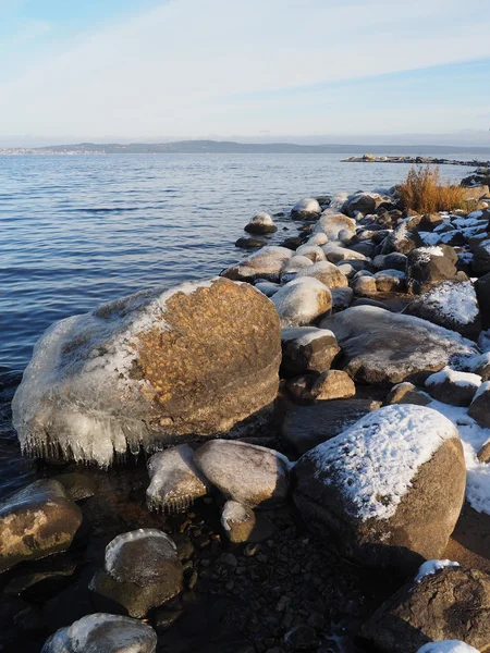 Stones in the ice on the lake — Stock Photo, Image