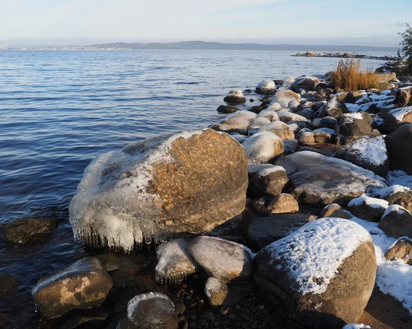 Pietre nel ghiaccio sul lago — Foto Stock