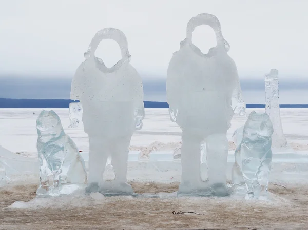 Eisstatuen von Männern mit Hunden auf dem See — Stockfoto