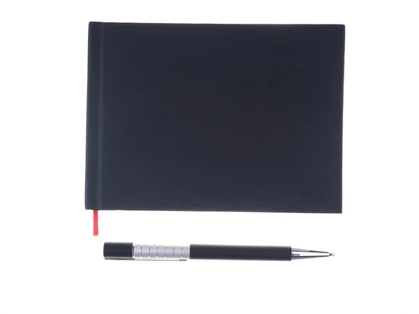 Cuaderno con un bolígrafo sobre un fondo blanco — Foto de Stock