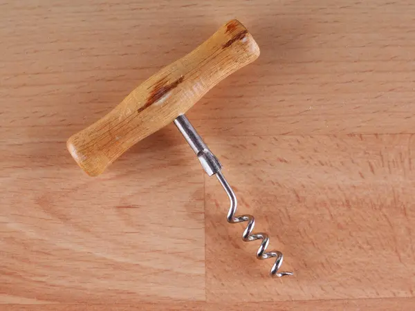 Corkscrew on a wooden background — Stock Photo, Image