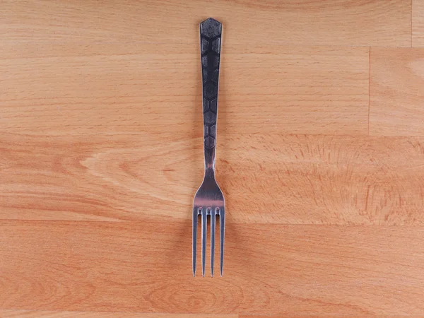 Tenedor sobre un fondo de madera — Foto de Stock