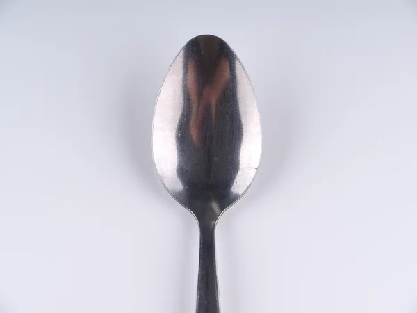 Spoon on gray background — Stock Photo, Image