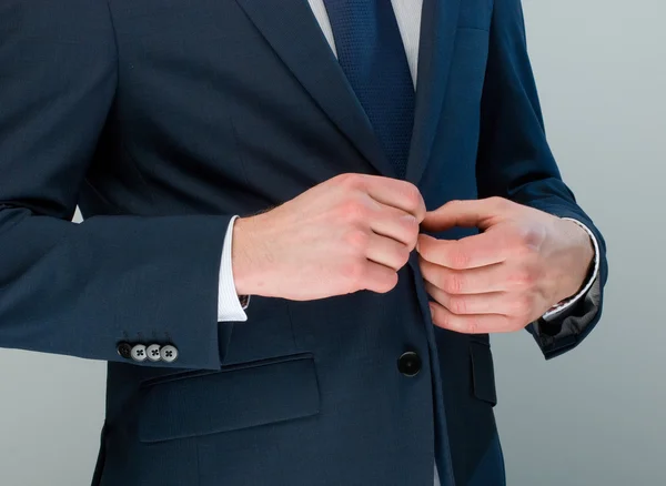 Man adjusting his jacket buttons. — Stock Photo, Image