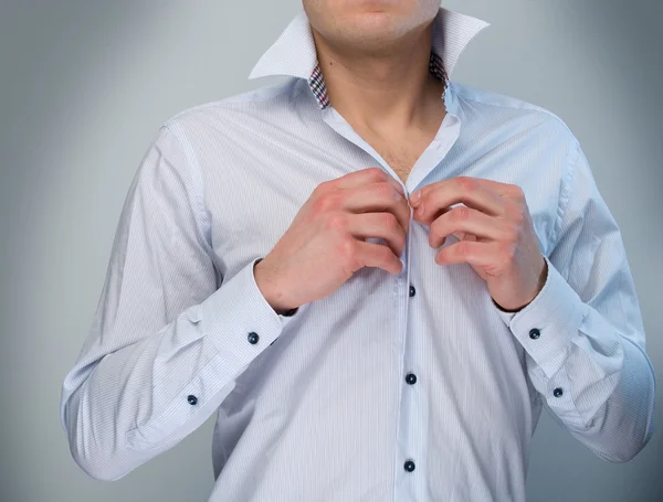 Człowiek, dostosowując jego guziki koszuli. — Zdjęcie stockowe