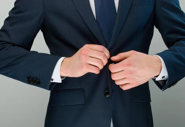 Man adjusting his jacket buttons. — Stock Photo, Image