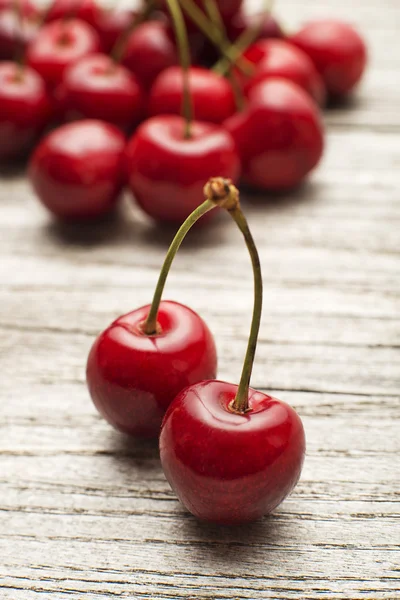 Cherry on wooden background close up. Royalty Free Stock Images