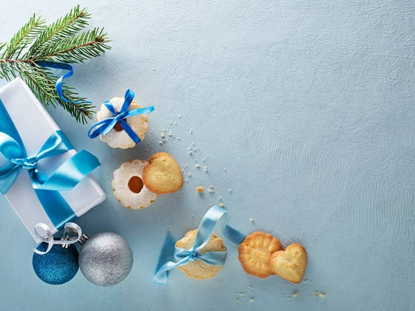 すべての形状とサイズのおいしい自家製クリスマスシュガークッキーとクリスマスブルーの冬の背景 コピースペース付きのトップビュー ストック写真