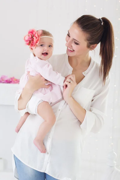 Happy mother holding her baby girl at home — Stock Photo, Image