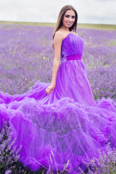 Happy girl with bouquet of lavender flowers — Stock Photo, Image