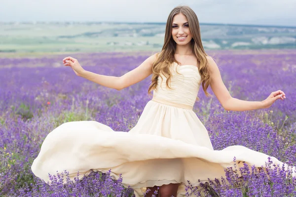 Lachende meisje in de jurk op Lavendel veld vliegen — Stockfoto