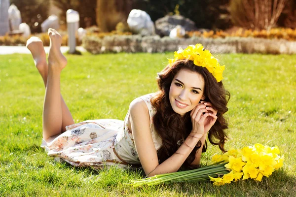 Menina sorridente feliz com flores amarelas — Fotografia de Stock